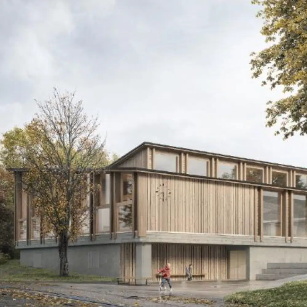 Contemporary wooden building with tall vertical slats and large windows, set in a park with trees.